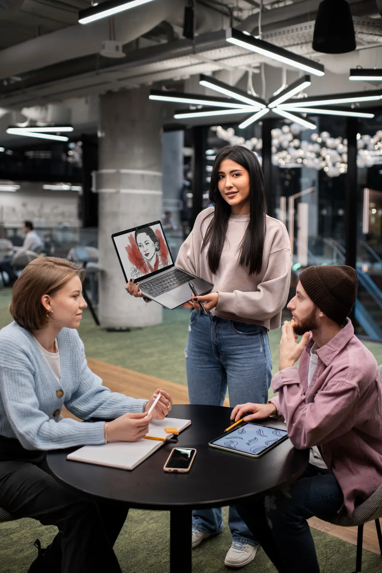 Pinky Brain Digital team reviewing a design project on a laptop with clients